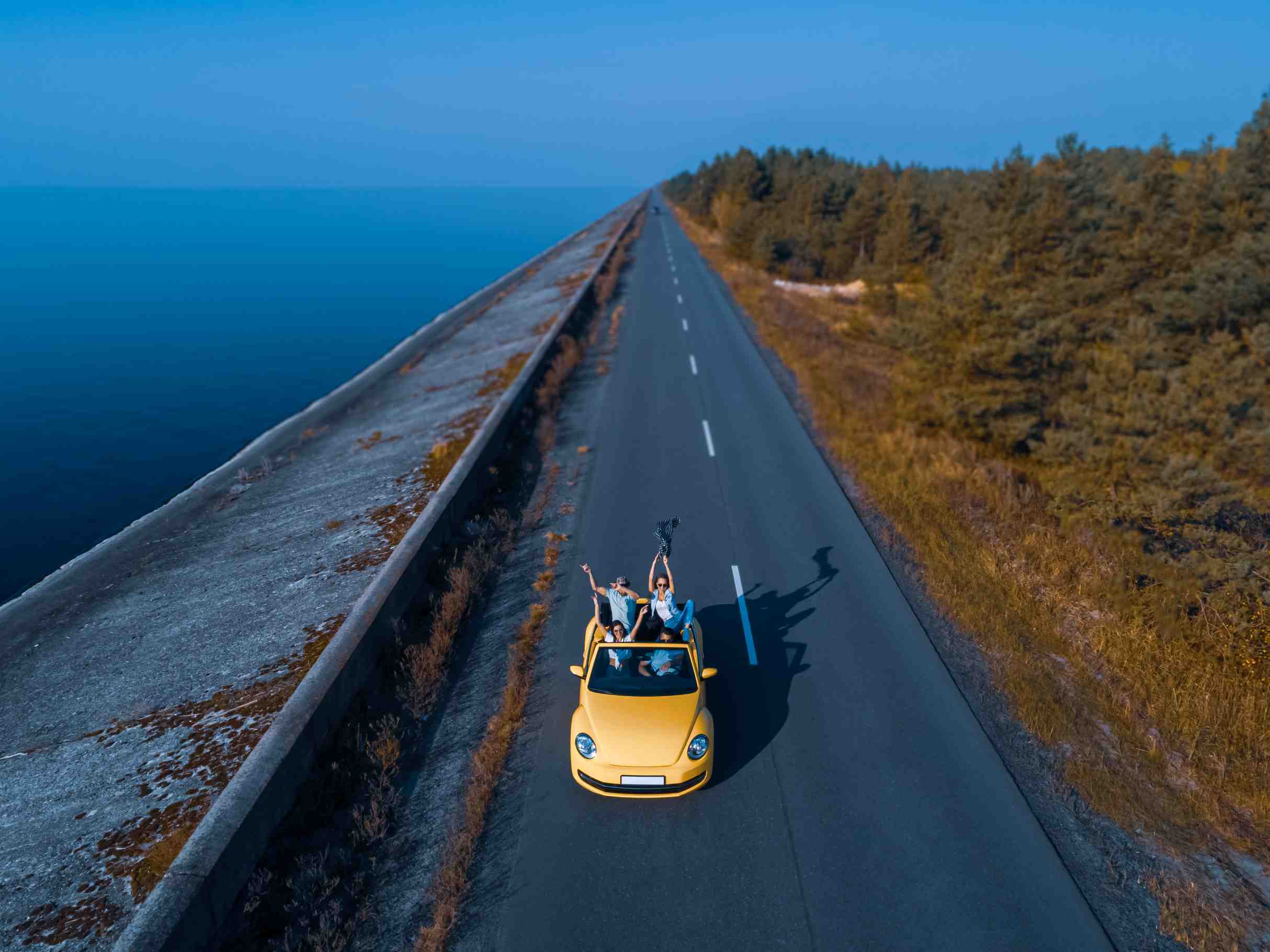 the-four-people-traveling-by-yellow-cabriolet-and-2023-11-27-04-58-34-utc